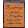 Frimærkepenge 1 Øre " Forsikring Tal med E.B. Secker" 